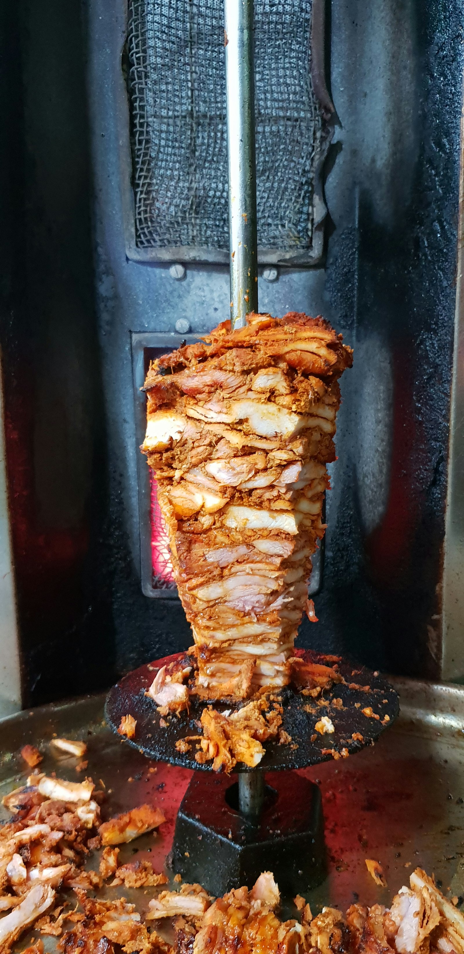 Vertical shawarma cooking on rotating spit