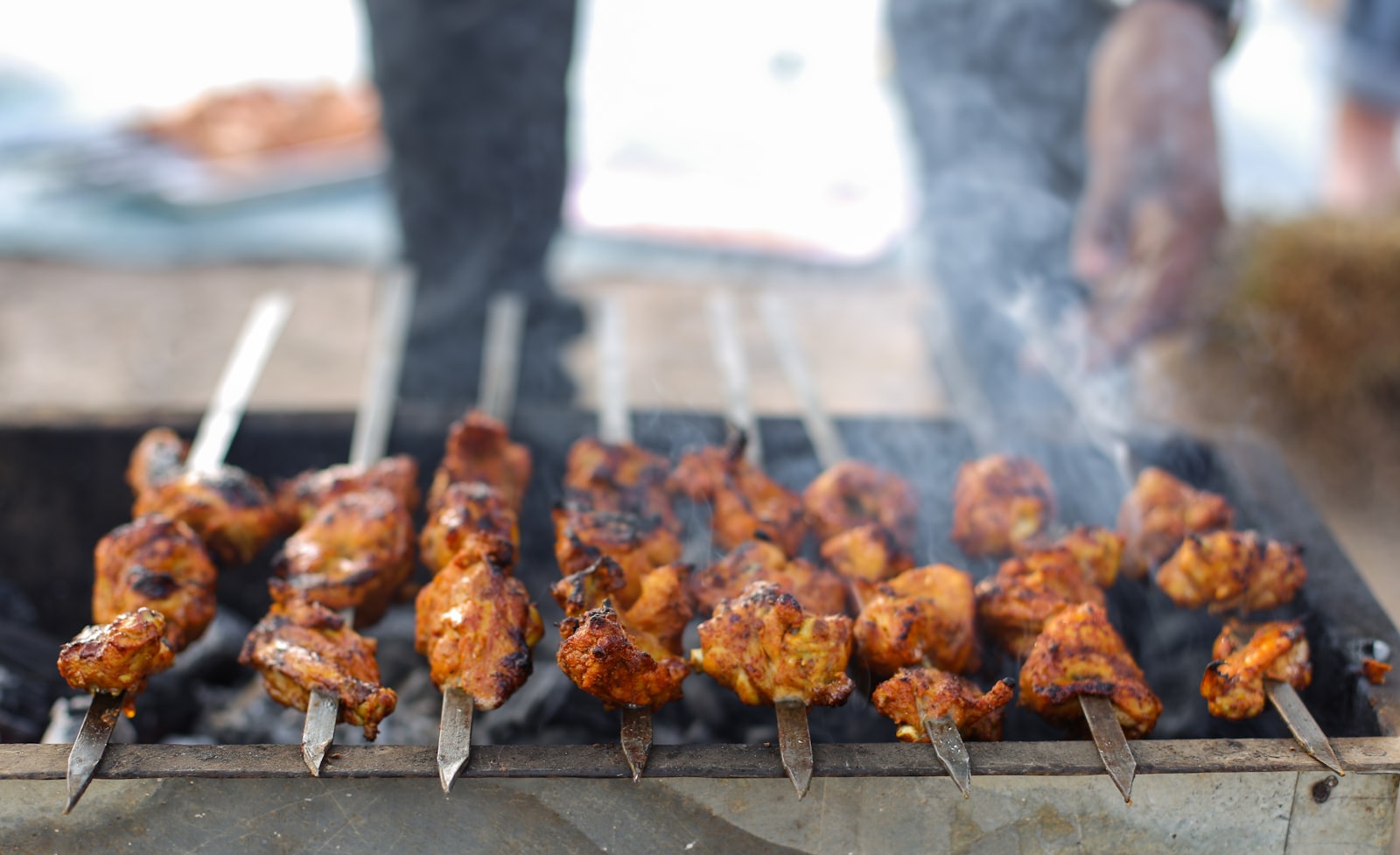 Mediterranean skewers grilling over charcoal